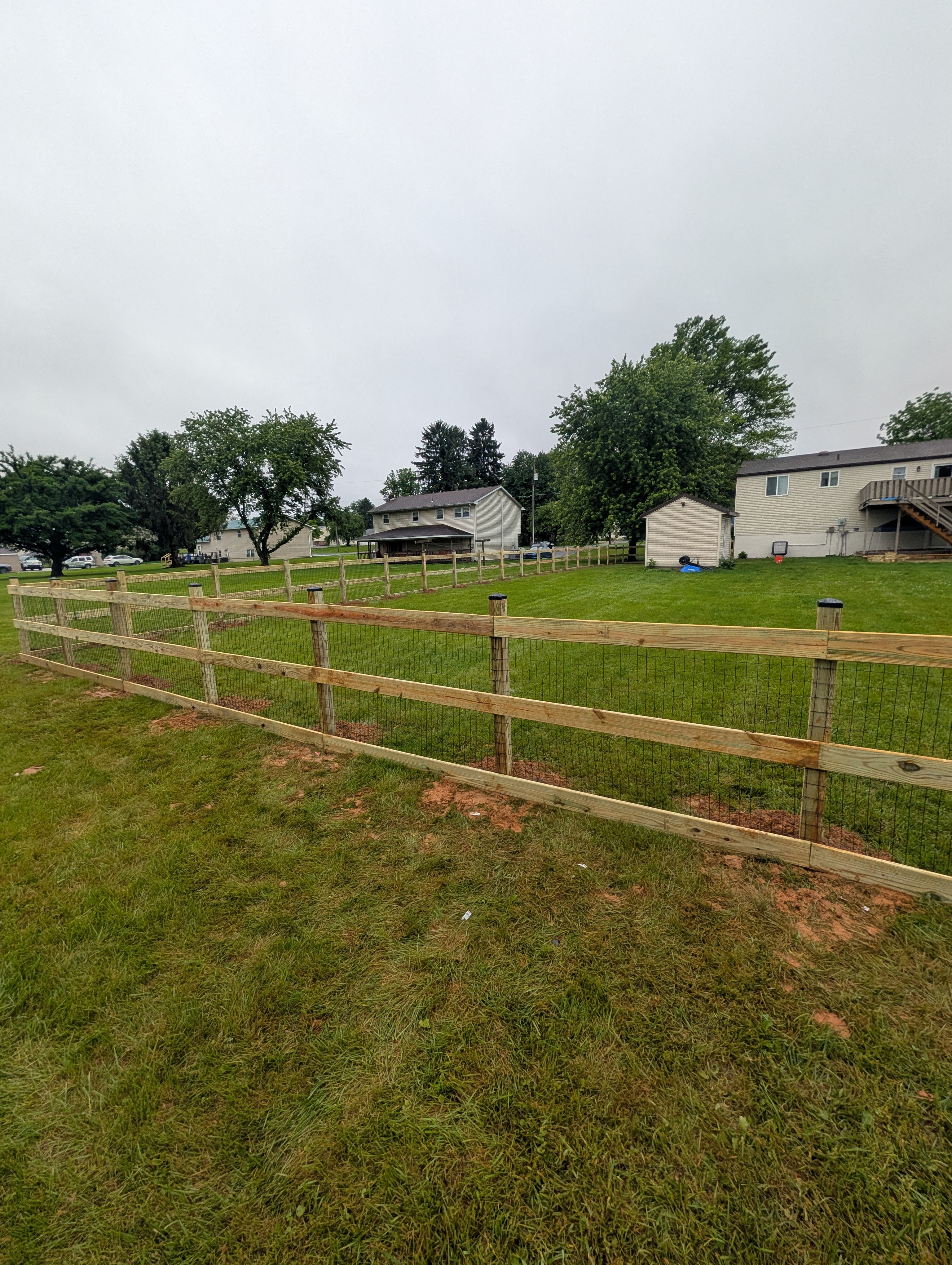 Long fence run with wire mesh
